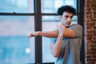 Chest and bicep upper body stretch can be done as an upper body warm-up exercise. (Photo via Pexels/Klaus Nielsen)